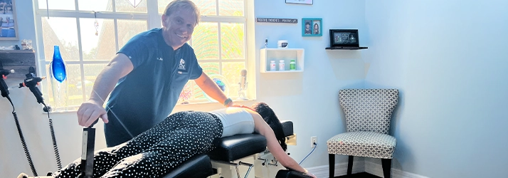 Chiropractor James Claeys Adjusting A Patients Back