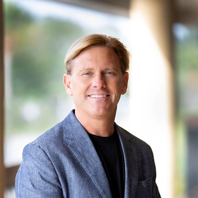Chiropractor James Claeys In A Suit Smiling